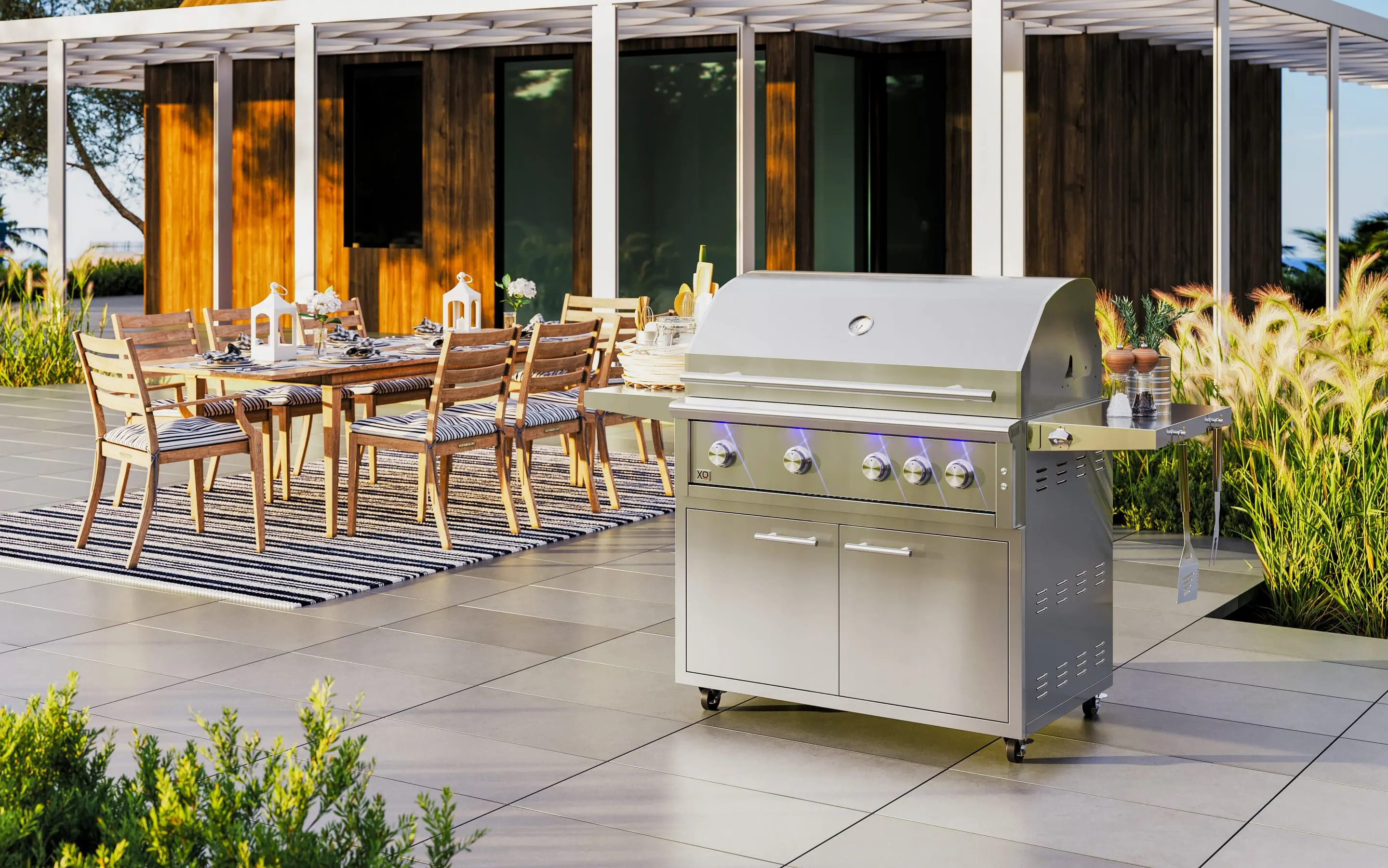 XO stainless steel grill beside a welcoming outdoor dining area