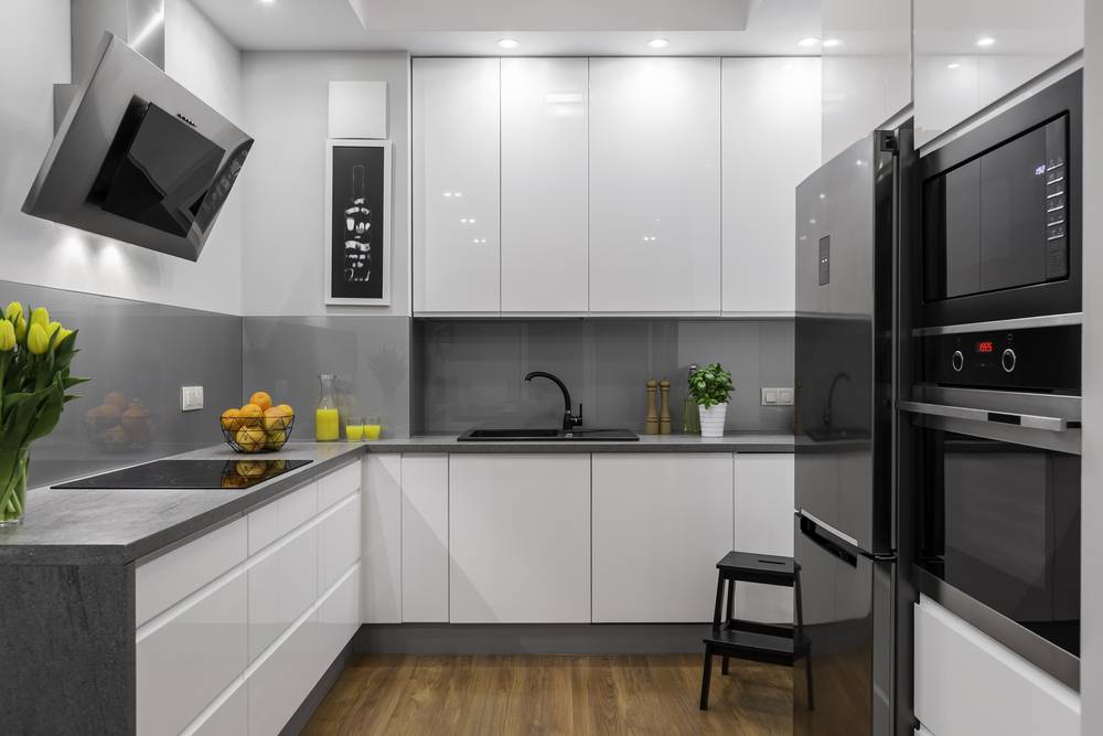 A gorgeous interior designer’s mock-up of a luxury, modern kitchen with an over-the-range microwave recessed and built in right above a compact, modern oven. A gorgeous interior designer’s mock-up of a luxury, modern kitchen with an over-the-range microwave recessed and built in right above a compact, modern oven.